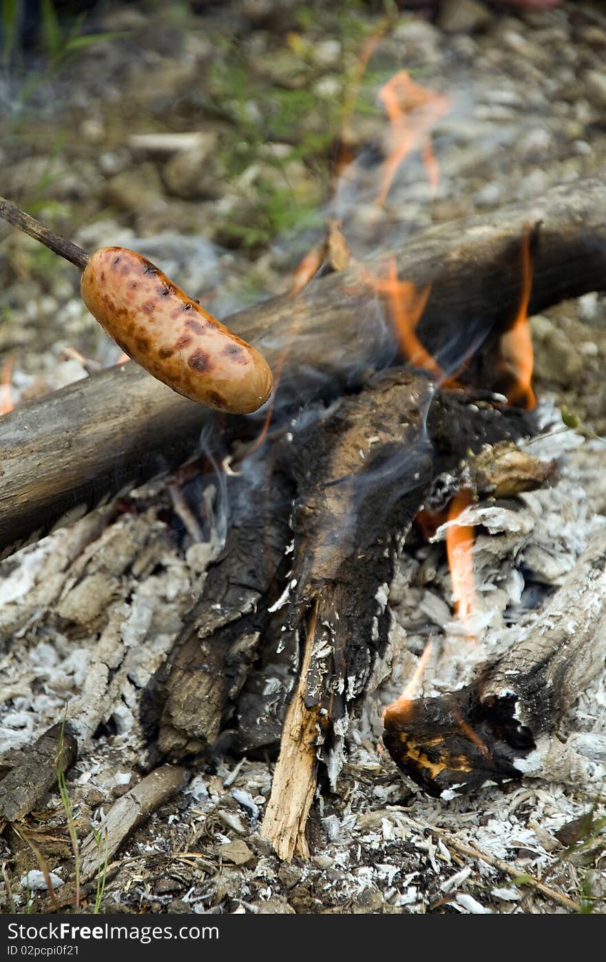 Sausage skewers roasted in the coals