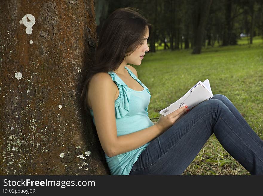 Young woman reading book in park