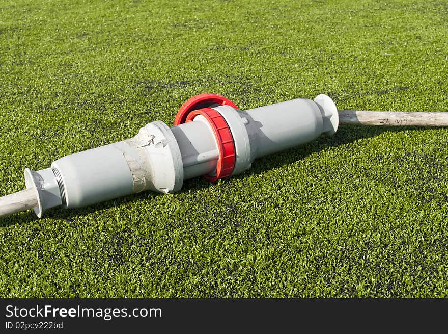 Connected wire in a soccer field on grass. Connected wire in a soccer field on grass