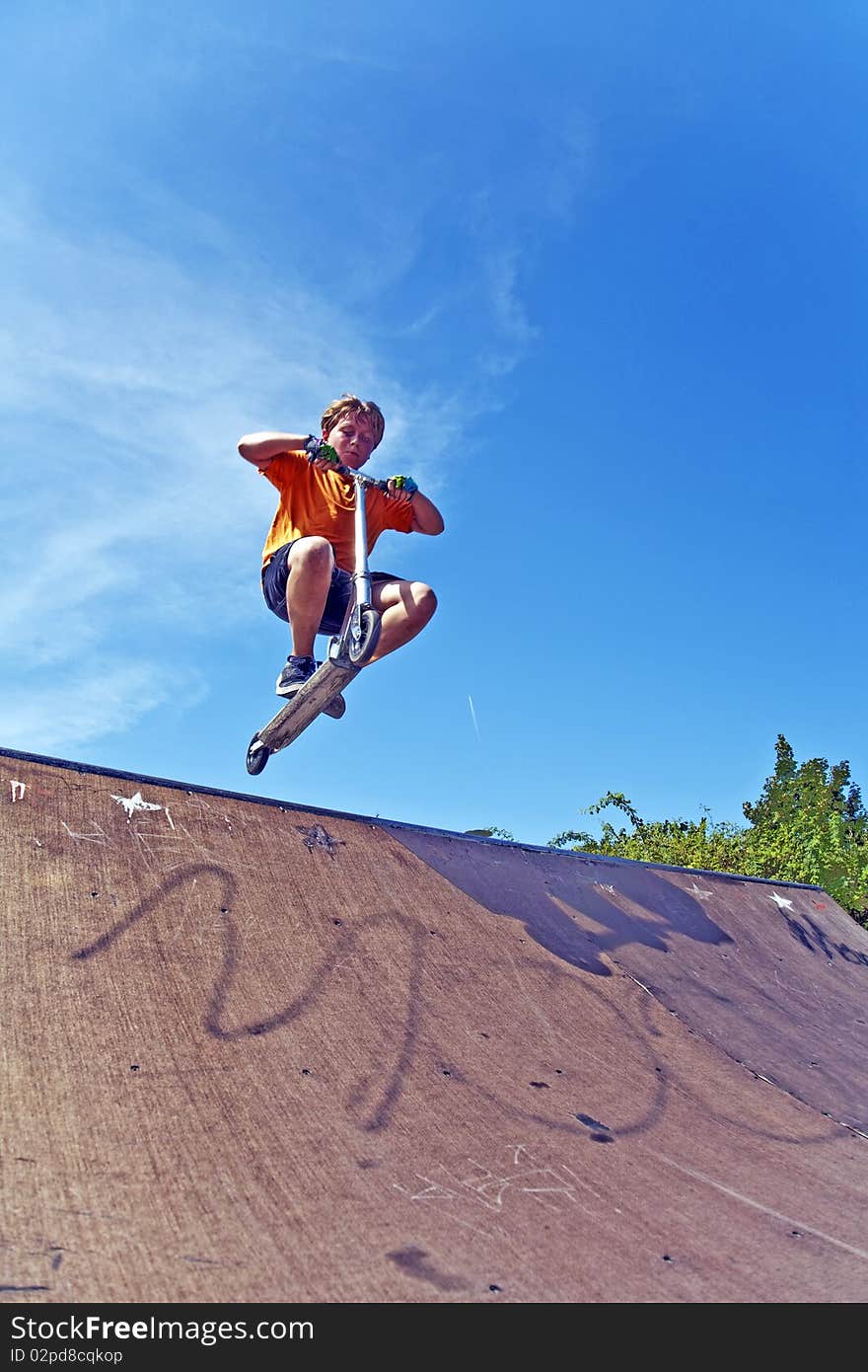 Boy with scooter at skate park