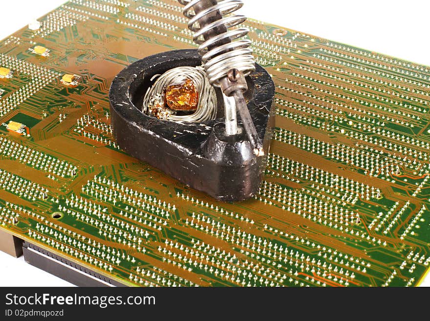 Soldering-iron and a printed circuit board isolated on white background. Soldering-iron and a printed circuit board isolated on white background