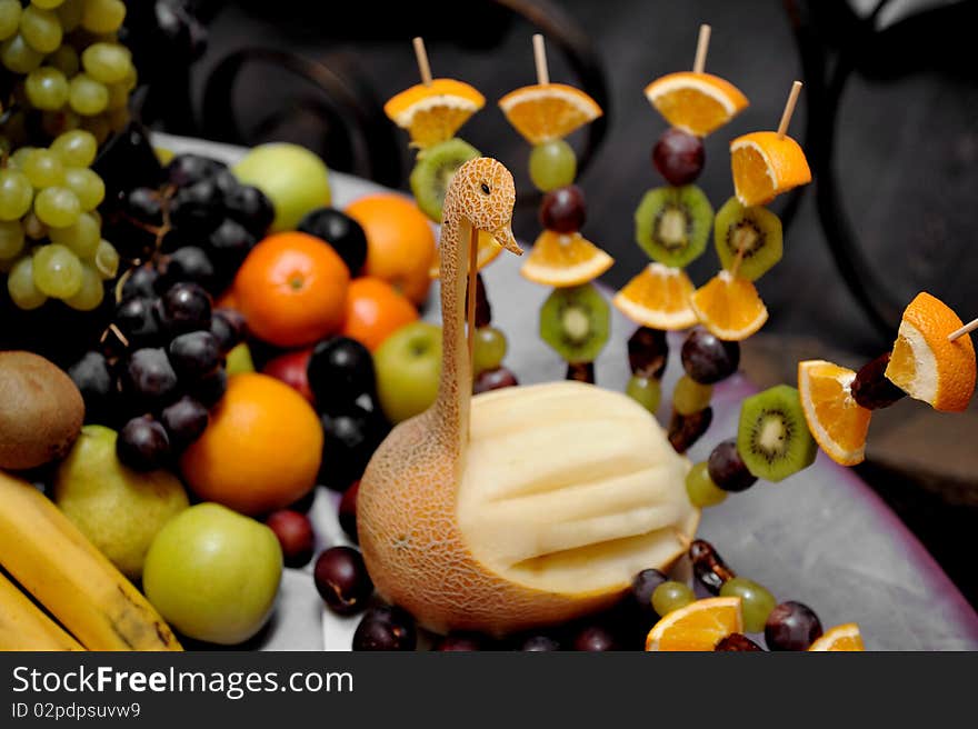 Fruit plate with bananas,kiwis, pineapples, apples, grapes