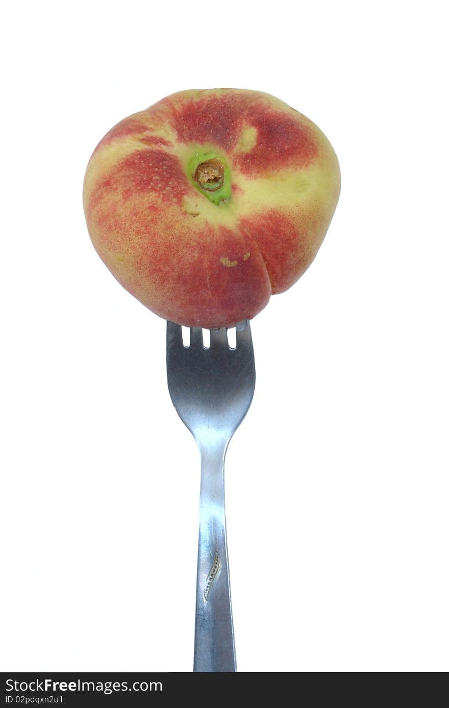 Peach (paraguaya) on the fork in isolated over white