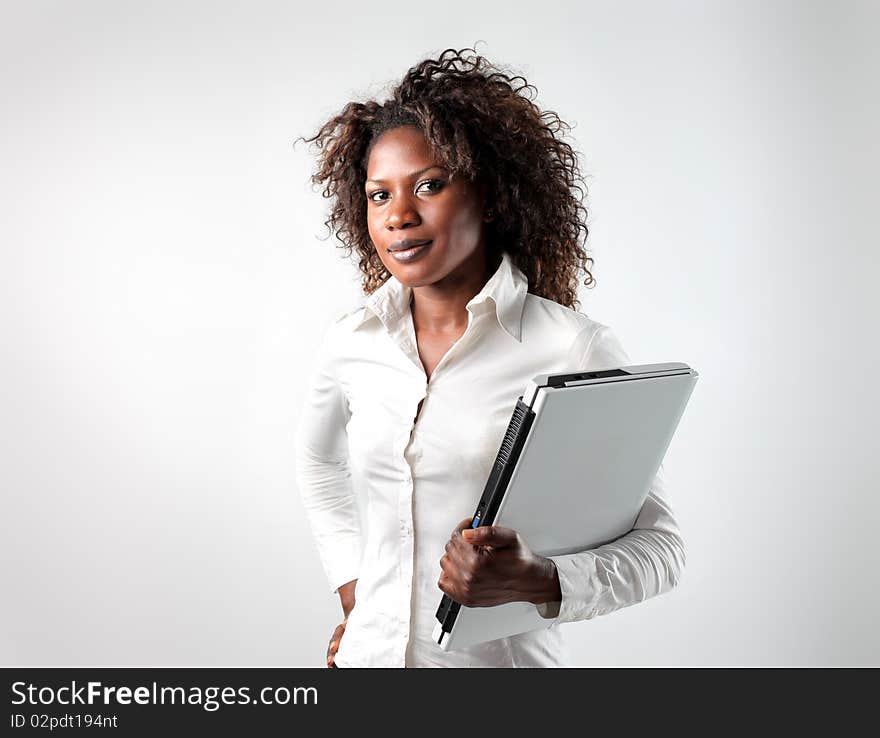 Young black businesswoman holding a laptop