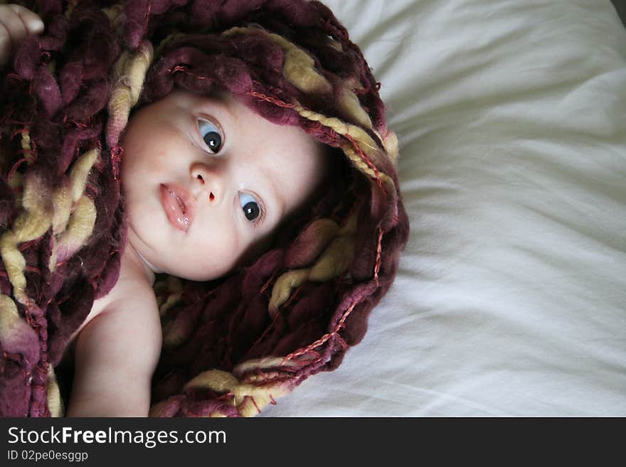 Baby boy wrapped up nice and warm, sucking his thumb