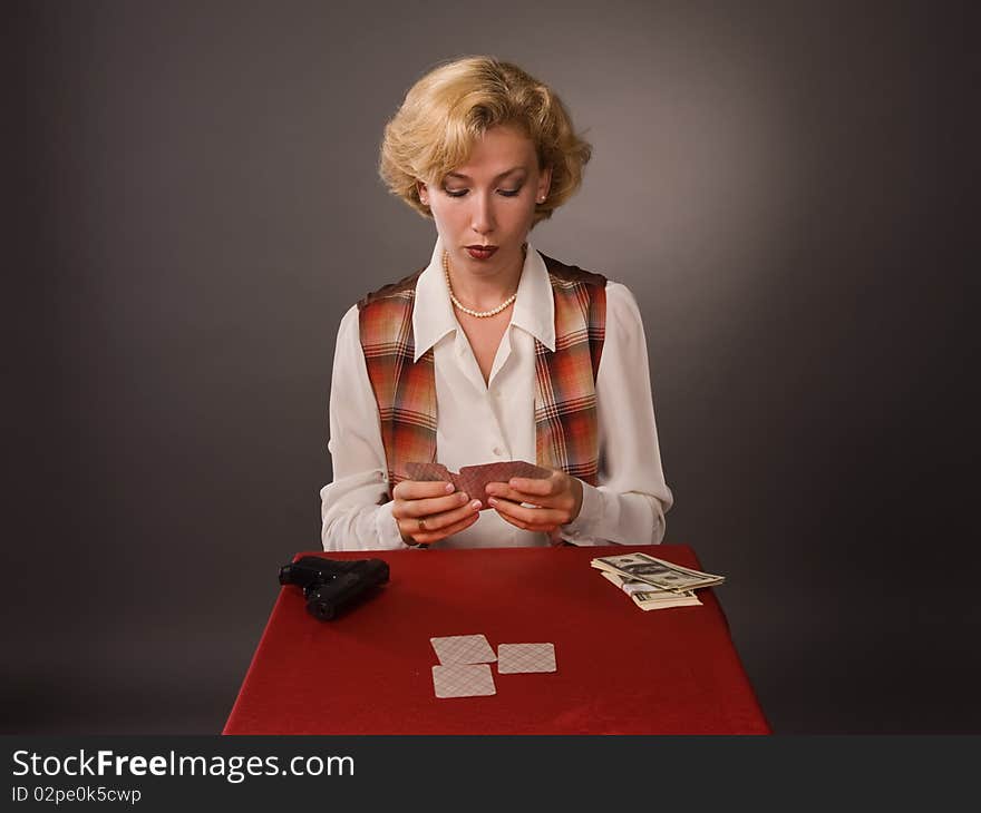 The pretty woman with cards on a grey background