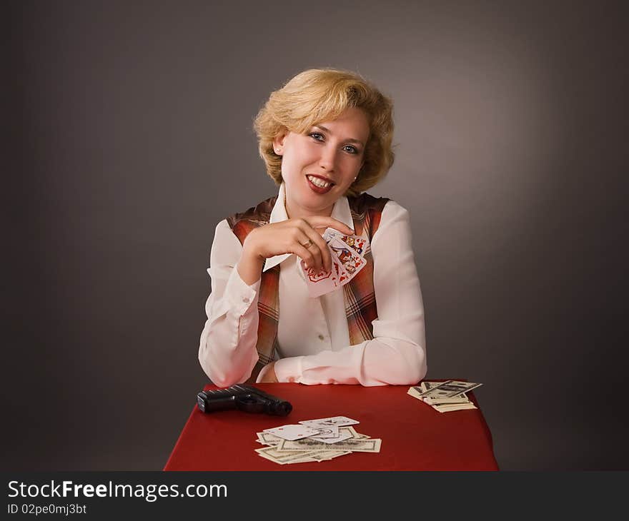 The pretty woman with cards on a grey background