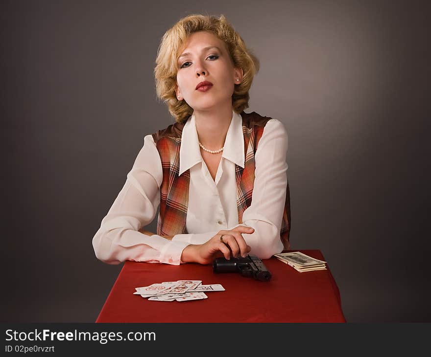 The pretty woman with cards on a grey background. The pretty woman with cards on a grey background