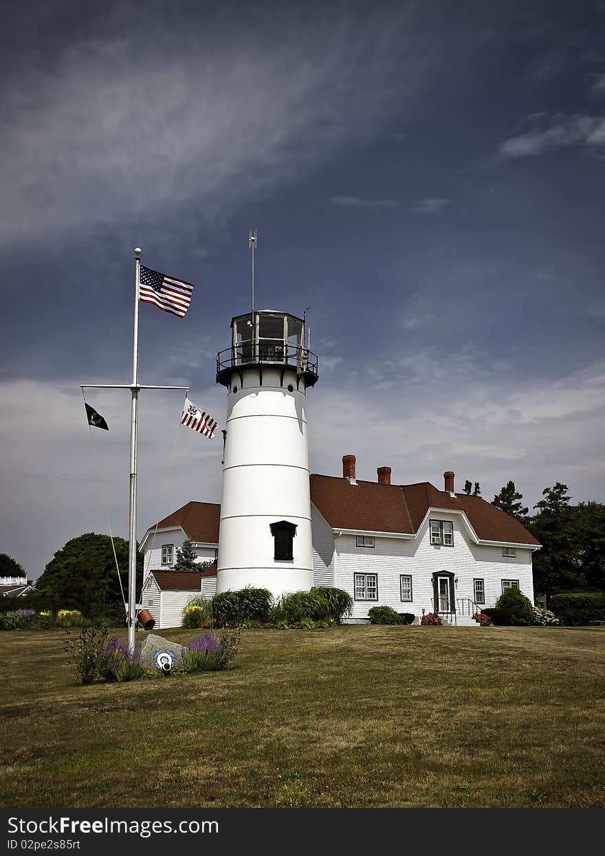 The united state coast guard station  at Chatham Ma protects the southern side of cape cod, the beautiful station stands tall framed by deep blue skies and the American flag flies high in the skies. The united state coast guard station  at Chatham Ma protects the southern side of cape cod, the beautiful station stands tall framed by deep blue skies and the American flag flies high in the skies