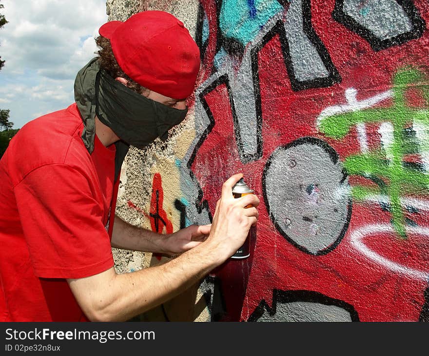 Graffity painter spraying on the wall