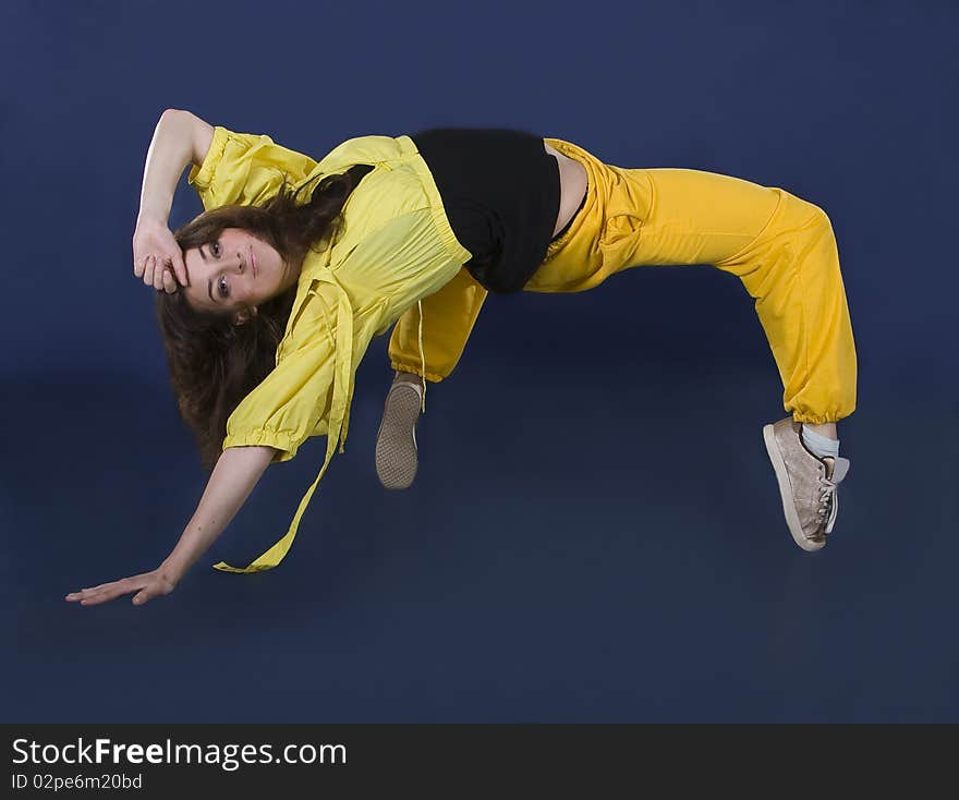 Teenage girl dancing hip-hop in the darkness