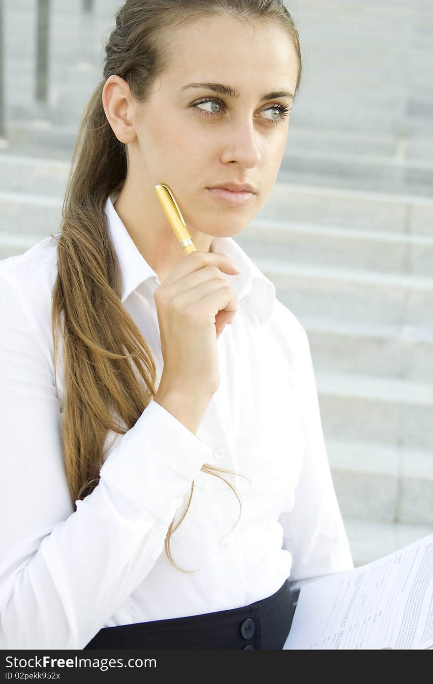 Young Businesswoman lost in thought over the signing of the document. Analyzes. Young Businesswoman lost in thought over the signing of the document. Analyzes