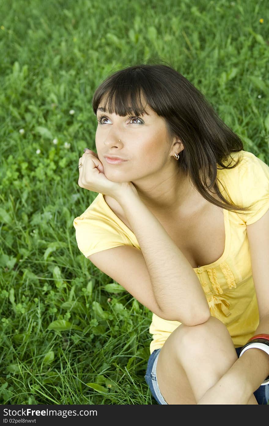 Young woman pensive outdoors in the park. Young woman pensive outdoors in the park