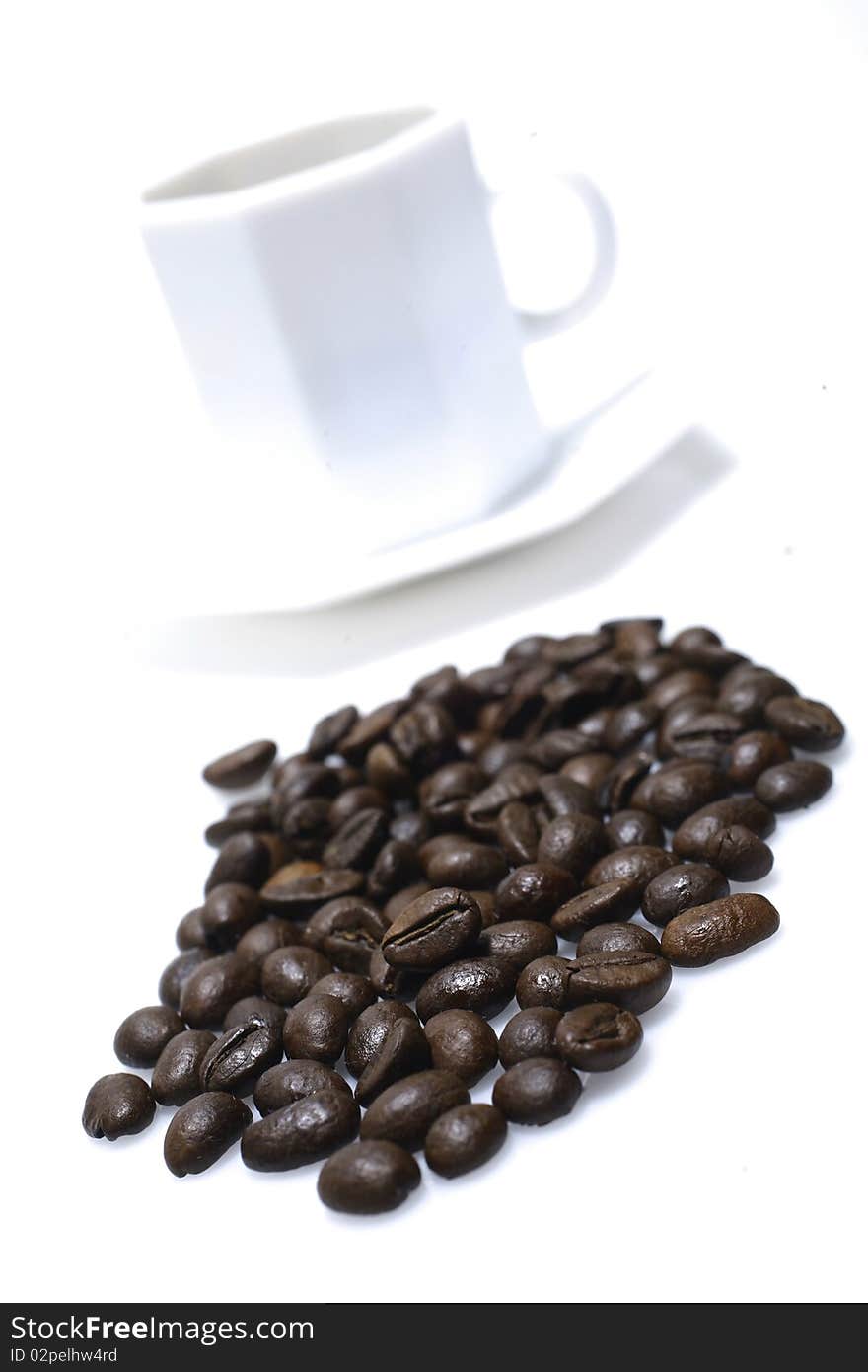 Grains of coffee and cup onwhite