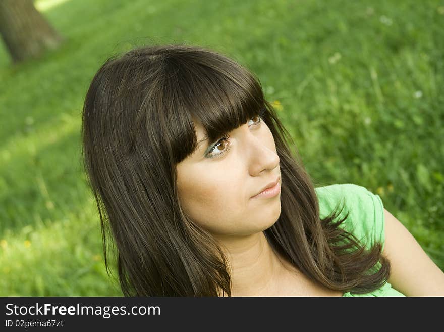 Young woman pensive outdoors in the park. Young woman pensive outdoors in the park