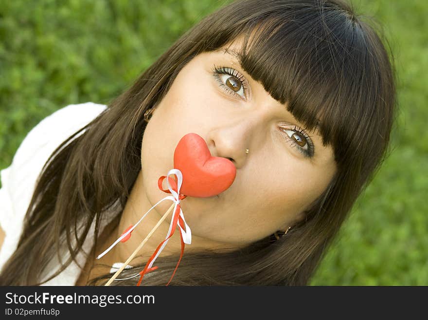 A beautiful young woman holding a red heart. Valentine. A beautiful young woman holding a red heart. Valentine