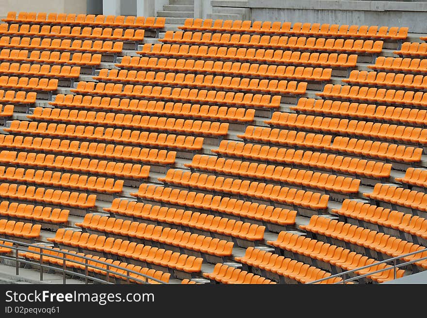 Empty orange seat in football stadium