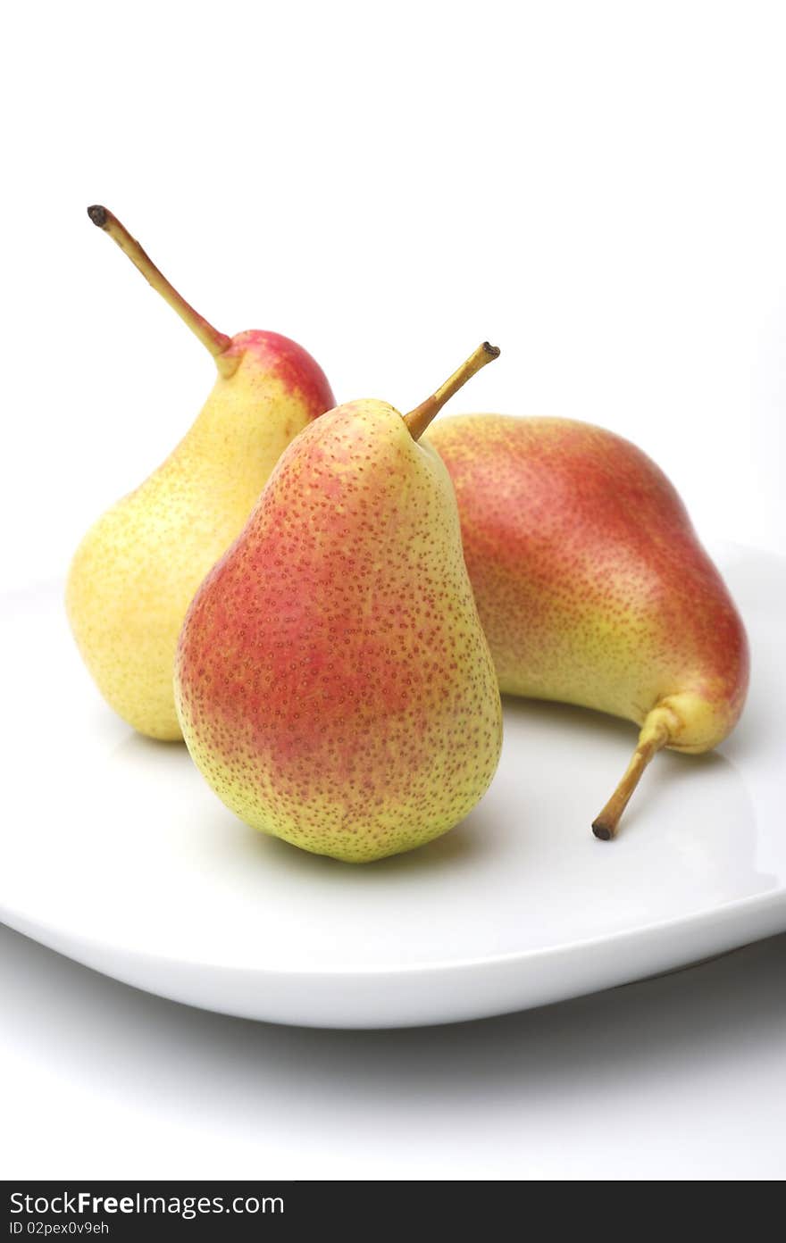 Three pears on a white plate