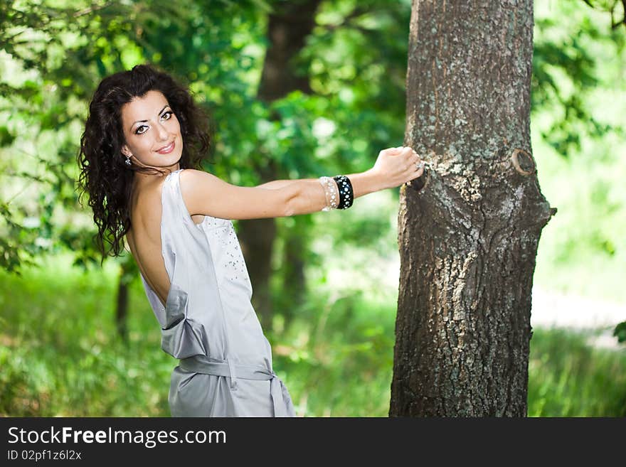 Tender girl in the garden with trees