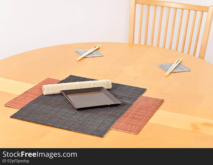 Bamboo Mats with Black Plate on Wood Table. Bamboo Mats with Black Plate on Wood Table