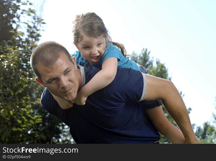 Father and daughter play at the backyard. Father and daughter play at the backyard.