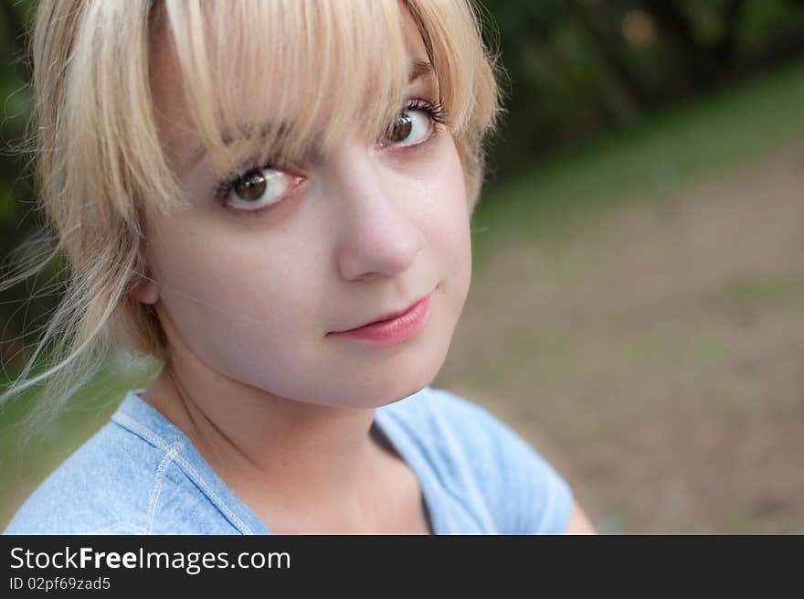 An attractive young female in a park. An attractive young female in a park.