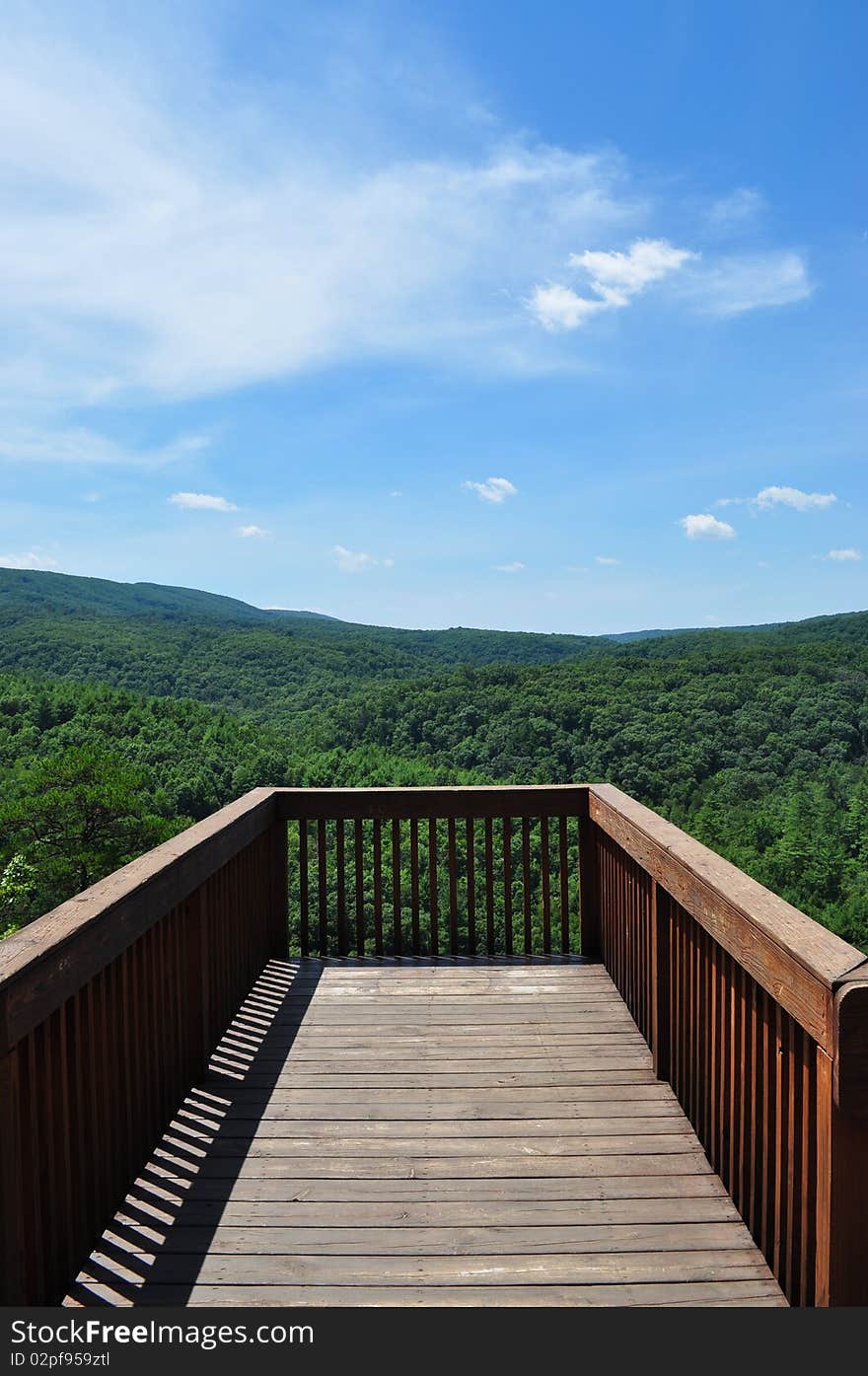 A wooden deck with a view of the mountains