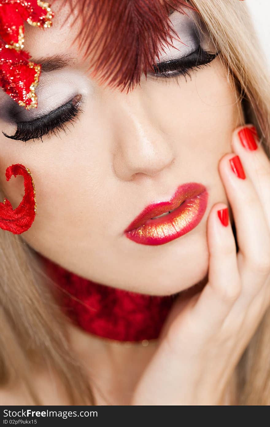 Beautiful fashionable woman with art leaves on head