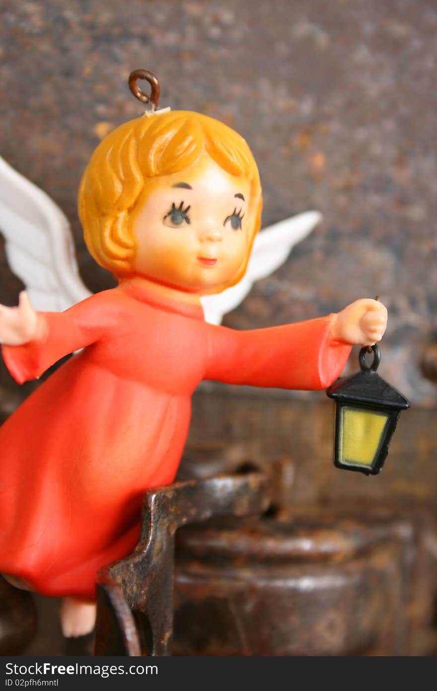 Antique christmas ornament of a little angel holding a lantern