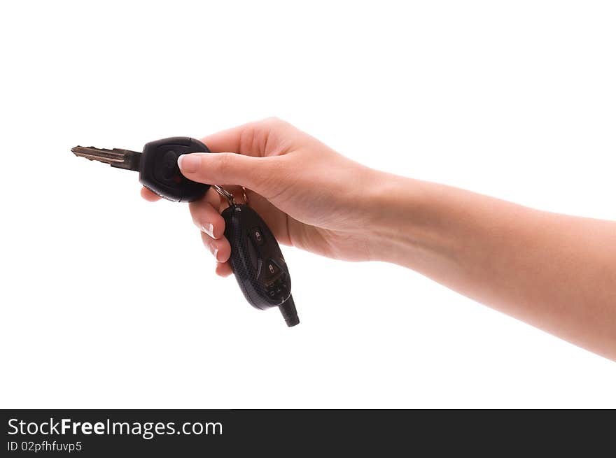 Woman's hand holds out key to the car. Isolated on white background. Woman's hand holds out key to the car. Isolated on white background.