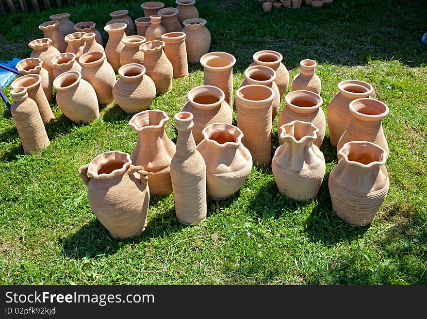 Old fashioned clay pots on grass