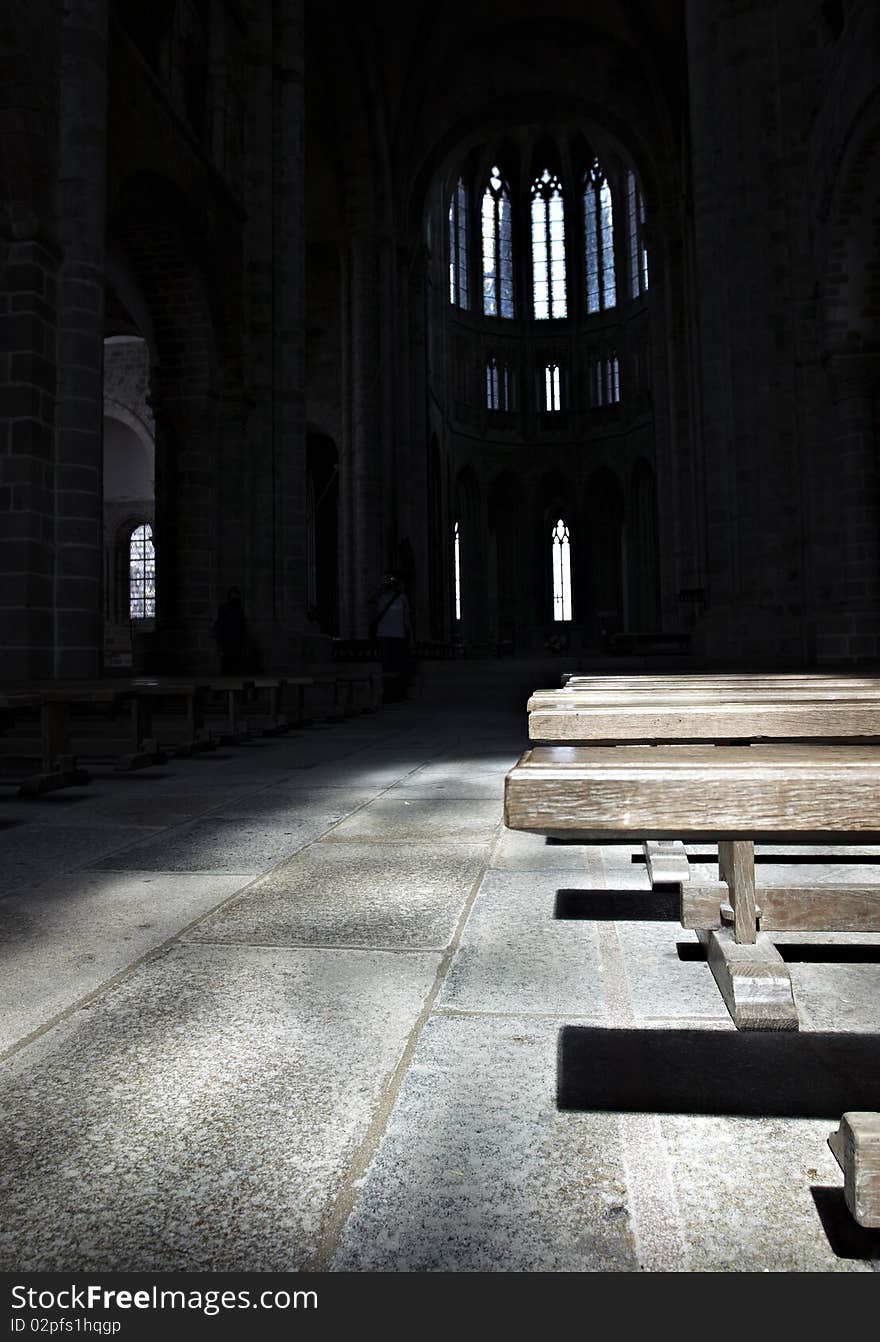 Pew illuminated by dim light in a church. Pew illuminated by dim light in a church