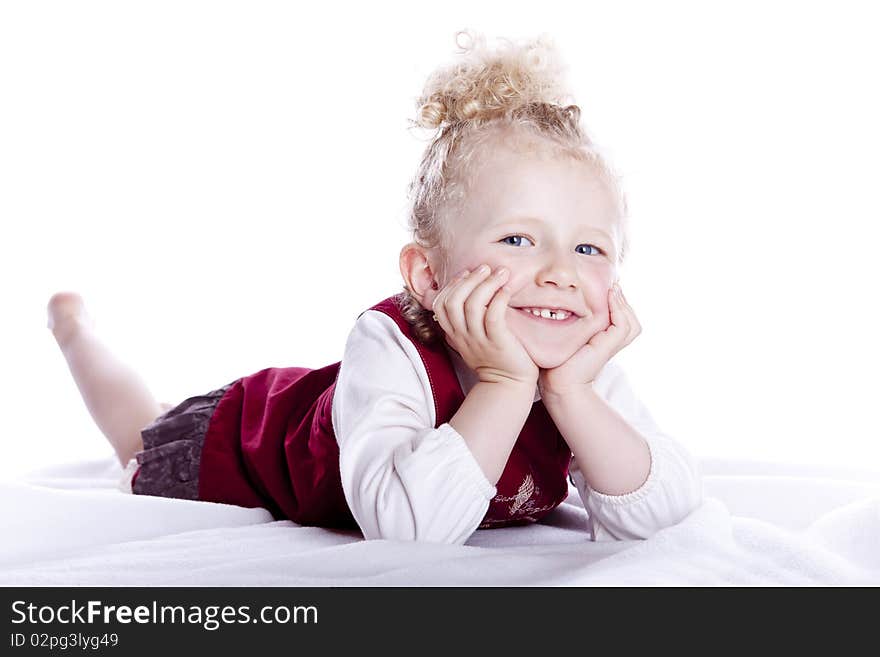 Small smiling baby in red dress on white background