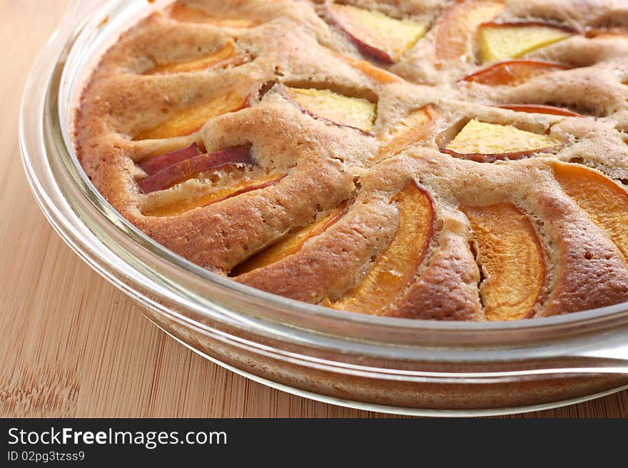 Apricot and peach pie on a transparent plate