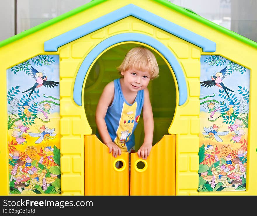 Cute boy in play house