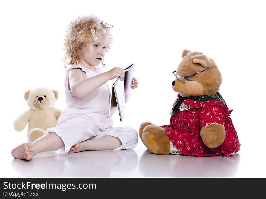 Cute baby girl with her teddy bear on white background