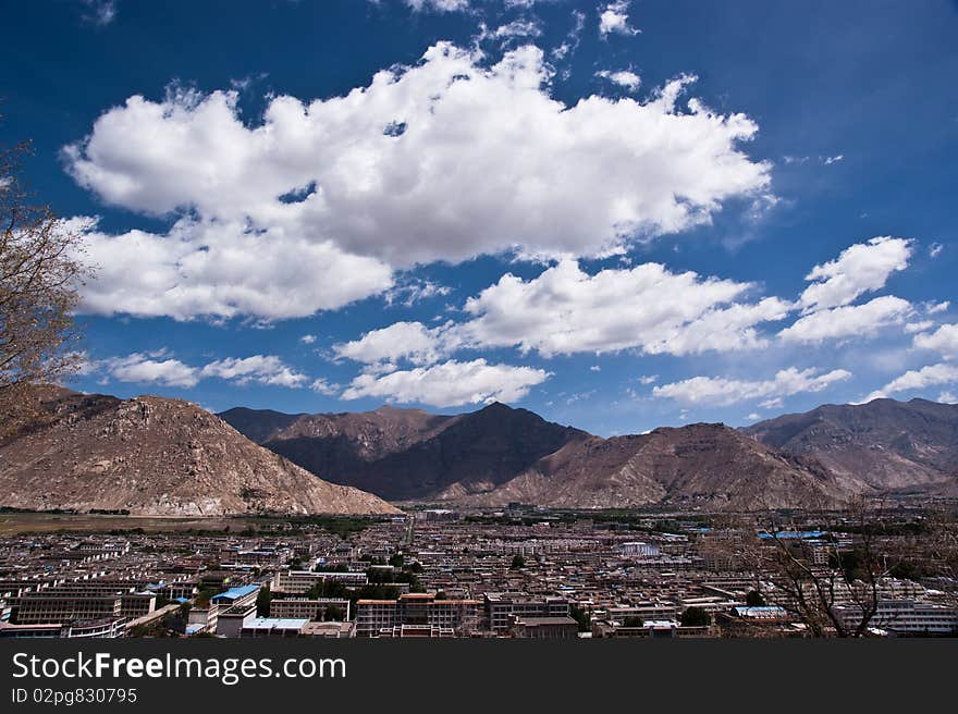 Lhasa city overview with great white cloudscape against blue sky