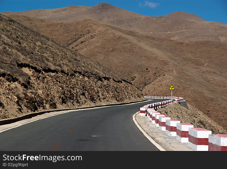 Yellowish mountain road view in tibet of China