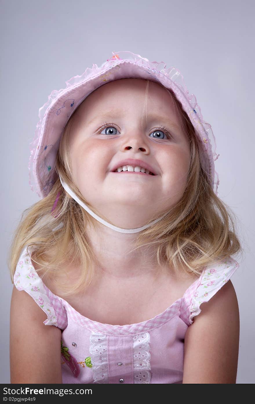 Beautiful little girl beging for something wearing a pink hat. Beautiful little girl beging for something wearing a pink hat