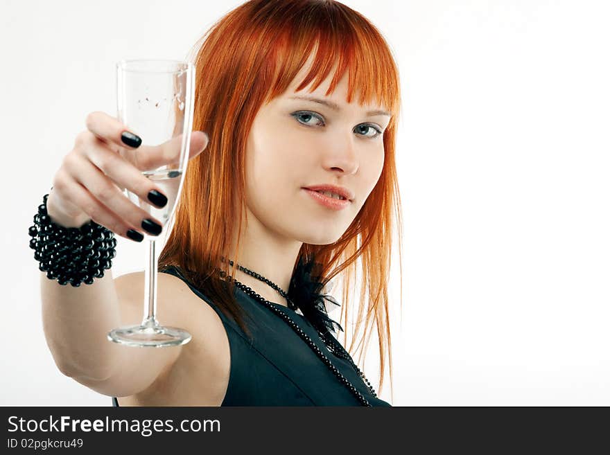 Beautiful red-haired girl lifts a toast, a glass with champagne