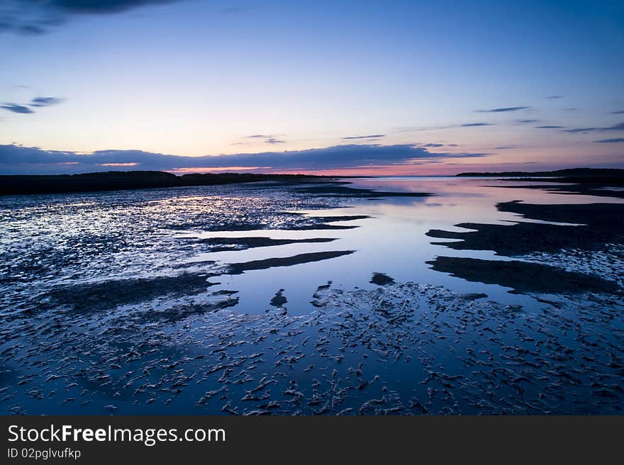 Reflected light on the sand and water at beach in Norfolk. Reflected light on the sand and water at beach in Norfolk