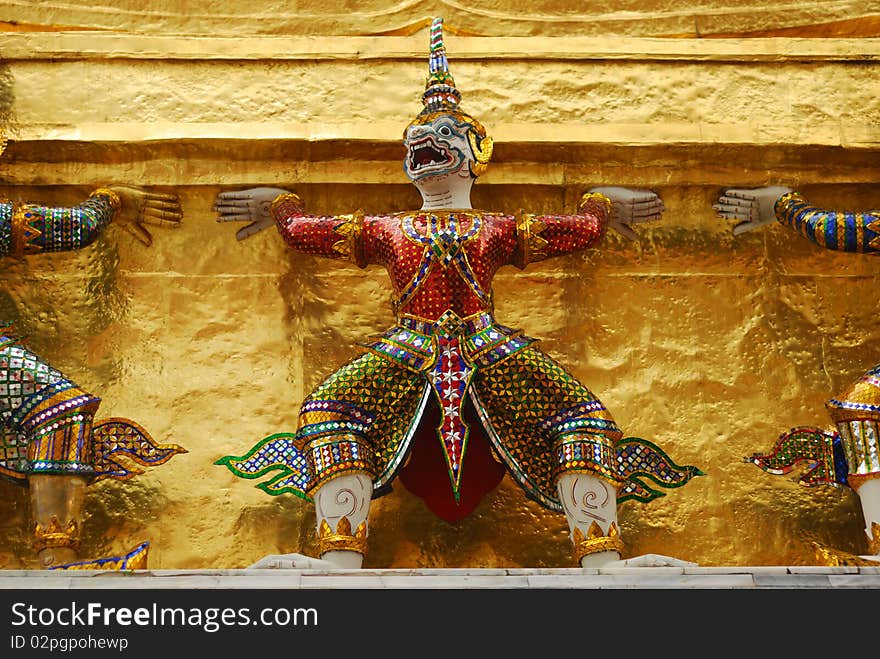 Giants raising golden pagoda in Prakaew temple. Giants raising golden pagoda in Prakaew temple.