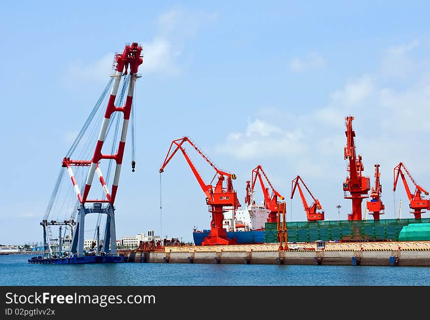 Mang cranes against blue sky，which taken in Qingdao Port China. Mang cranes against blue sky，which taken in Qingdao Port China