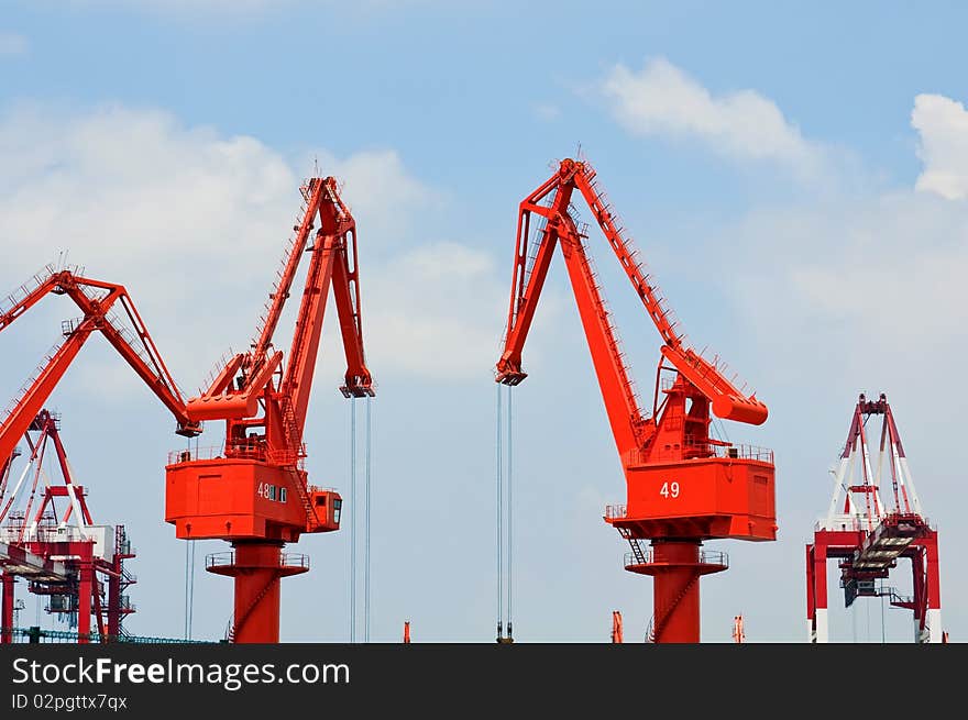 Mang cranes against blue sky，which taken in Qingdao Port China. Mang cranes against blue sky，which taken in Qingdao Port China