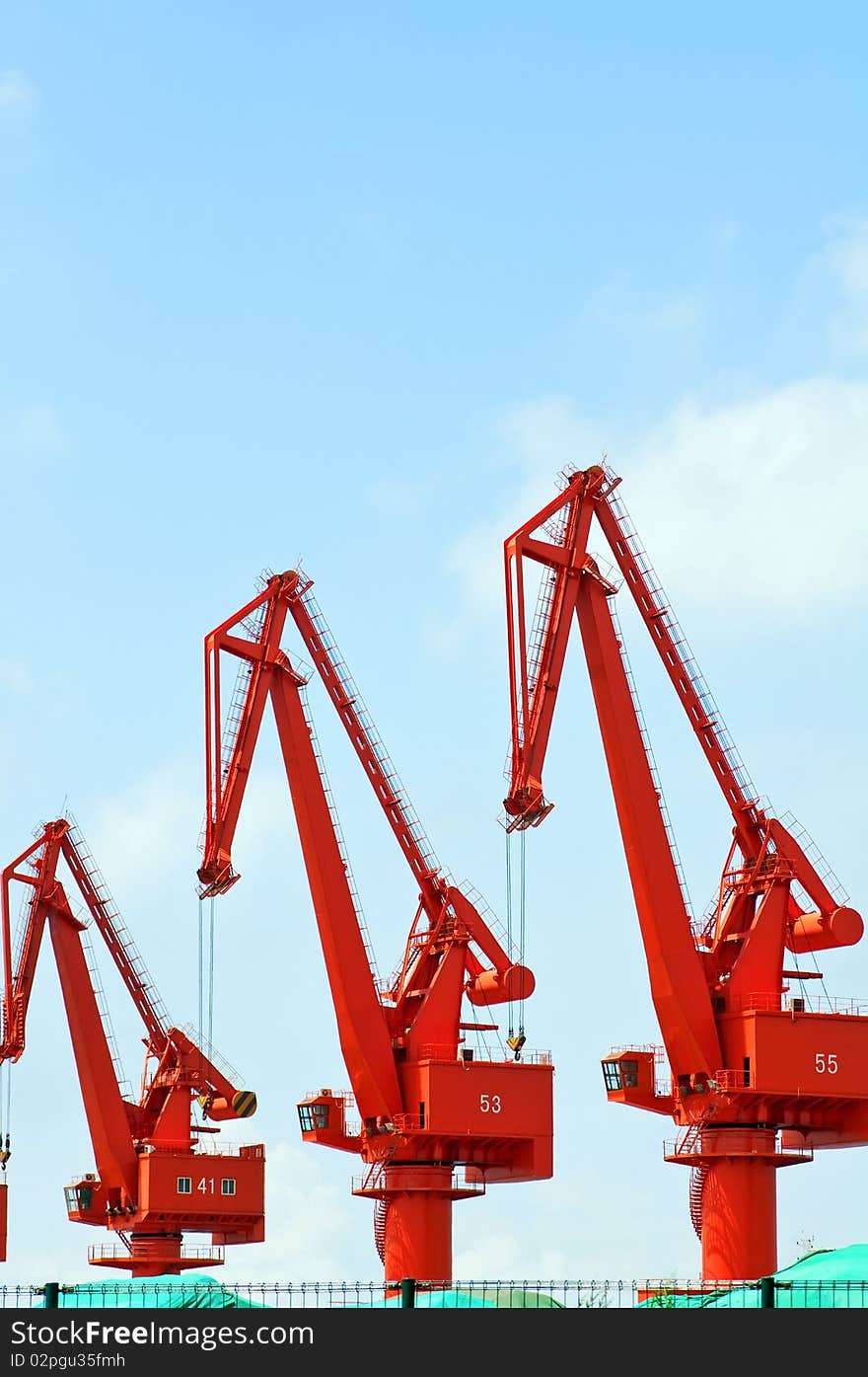 Mang cranes against blue sky，which taken in Qingdao Port China. Mang cranes against blue sky，which taken in Qingdao Port China