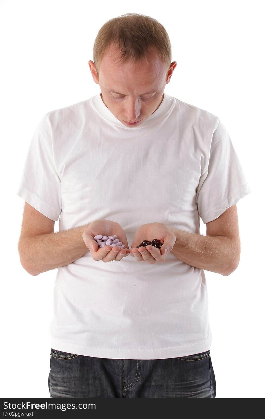 Man chooses from two different vitamin. Isolated on white background. Man chooses from two different vitamin. Isolated on white background