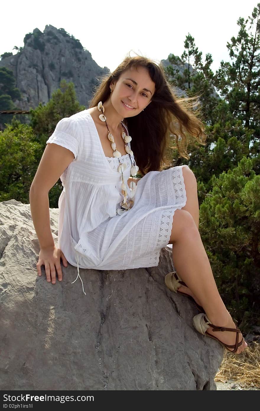 Young Girl In White Dress On The Rock