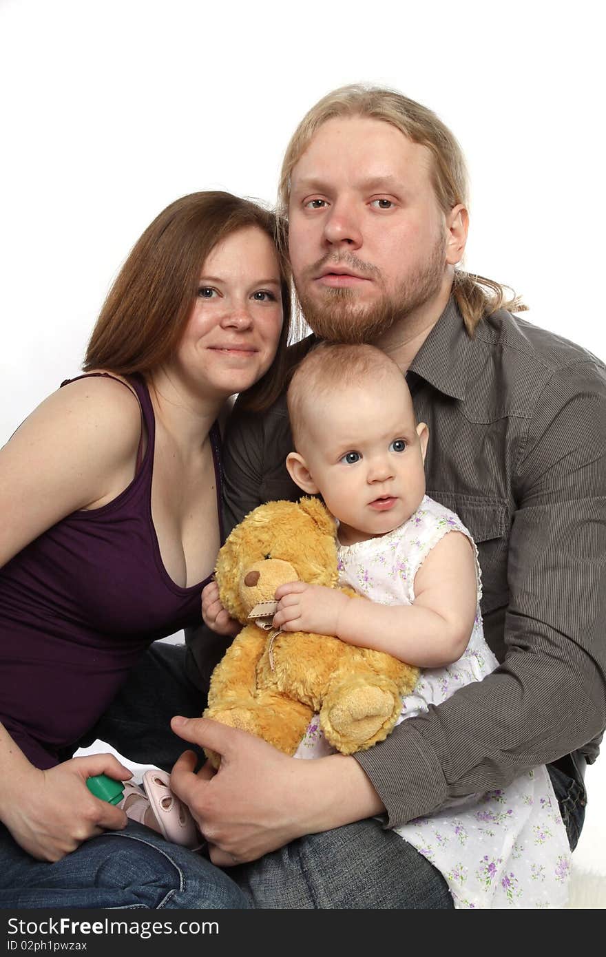 Joyful family: father, mother and baby with a toy. Joyful family: father, mother and baby with a toy