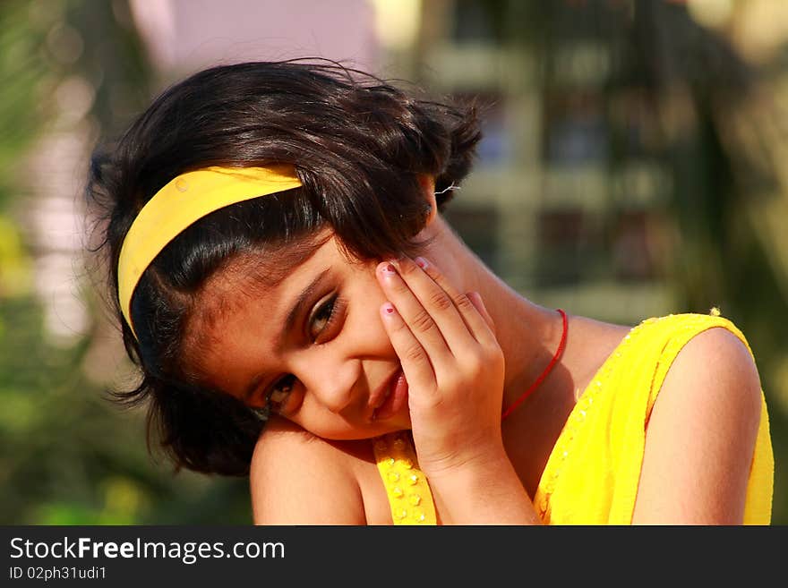 A closeup of a small Indian girl frowning from the onlooker. A closeup of a small Indian girl frowning from the onlooker.