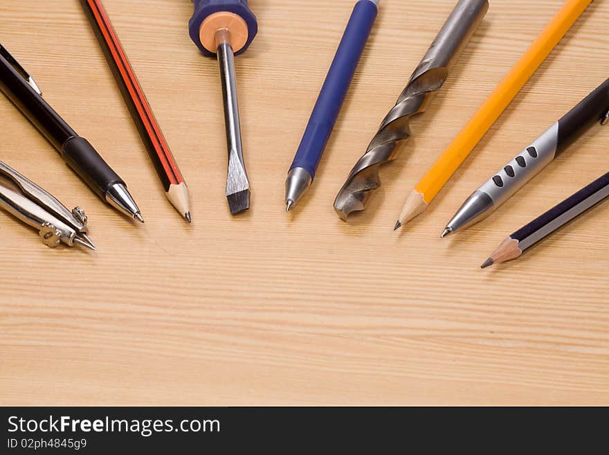 Tools and pens at wood table